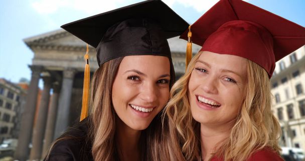Close-up of two college girls celebrating graduation near the Pantheon in Rome - Photo, Image
