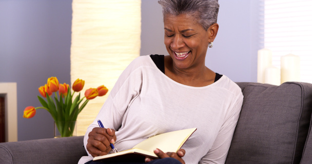 Mulher negra madura escrevendo em diário
 - Foto, Imagem