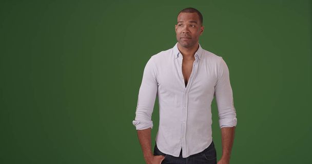 Handsome young black man standing on green screen - Photo, image