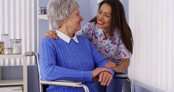 Happy senior woman with friendly Mexican caregiver - Photo, Image