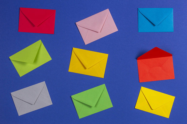 Colorful envelopes on blue background, top view - Zdjęcie, obraz
