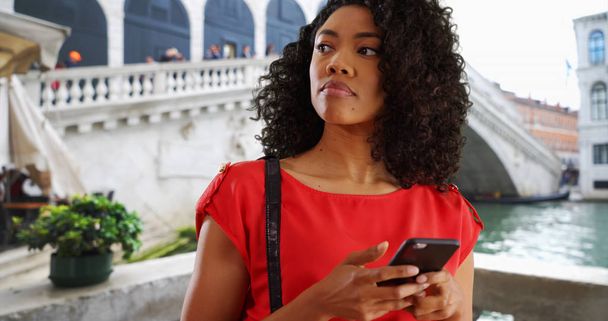 Happy afroamerické ženy turista v Benátkách textové zprávy na mobilní telefon  - Fotografie, Obrázek