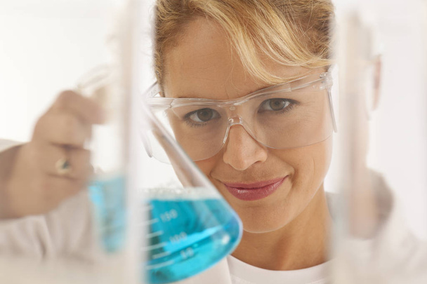 Close-up of scientist holding beaker - Photo, Image