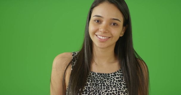 Charming young Latina posing on green screen - Photo, Image