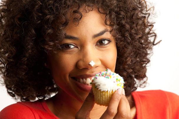 Closeup portrait of millennial black woman eating cup cake dessert - Foto, Imagen