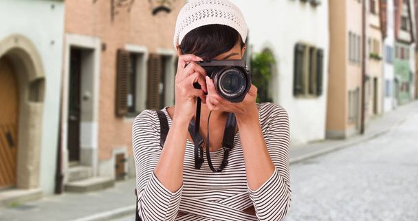 Woman with camera taking photo on Venice Italy city street - Photo, Image
