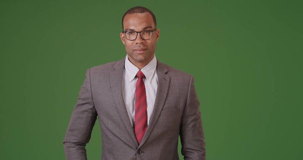 A black businessman poses for a portrait on green screen - Photo, Image