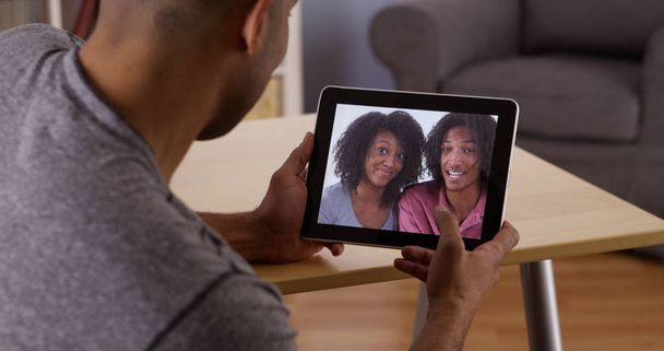 African man talking to relatives with tablet - Photo, Image