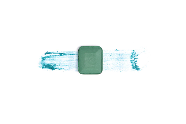 top view of eyeshadow of green color with stroke on white background - Foto, immagini