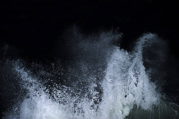 Splashing wave on the Black sea in the night. - Foto, afbeelding