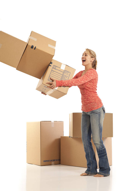 Young woman dropping cardboard boxes - Foto, immagini