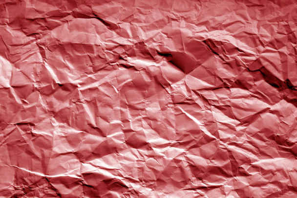 Crumpled sheet of paper with blur effect in red tone. Abstract background and texture for design. - Foto, afbeelding
