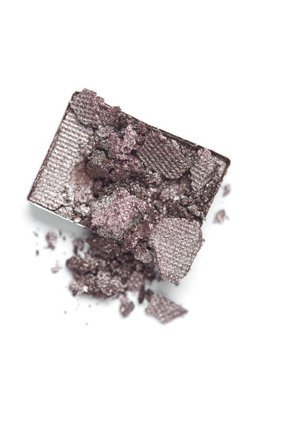 top view of cracked grey eyeshadow on white backdrop - Foto, afbeelding