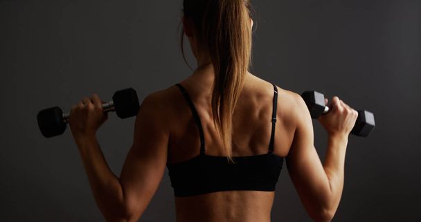 Fit healthy woman lifting weights - Photo, Image