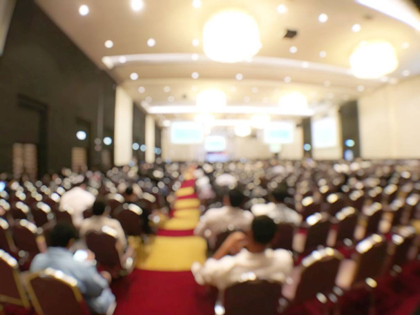 Education concept, Abstract blurred background image of students and business people  studying and discuss in large hall profession seminar with screen and projector for showing information. - Photo, Image