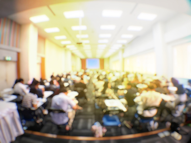 Education concept, Abstract blurred background image of students and business people  studying and discuss in large hall profession seminar with screen and projector for showing information. - Photo, Image