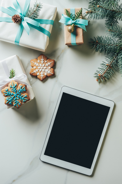 top view of christmas presents, snowflake cookies and digital tablet with blank screen on marble background - Photo, Image