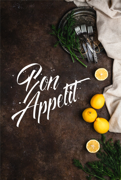 top view of vintage plate with fennel and forks on dark surface, bon appetit lettering - Zdjęcie, obraz