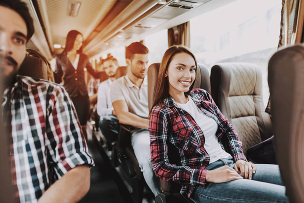Young Smiling Woman Traveling on Tourist Bus. Happy Beautiful Woman Relaxing on Passenger Seat of Tour Bus. Traveling, Tourism and People Concept. Friends on Trip. Happy Summer Vacation - Photo, image