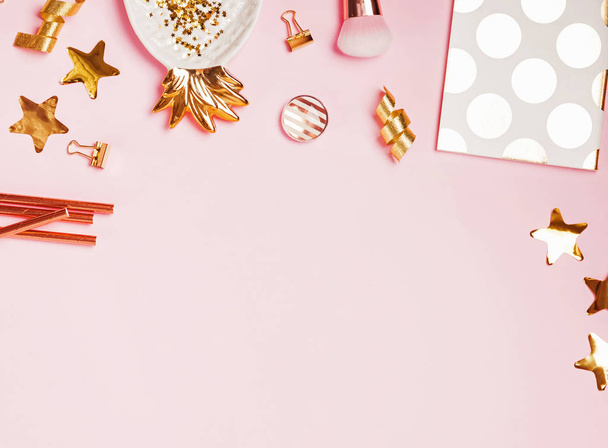 Golden decor and feminine accessories on the pink background - Photo, image