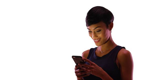 Gorgeous black female texting on cell phone on white background with copyspace - Photo, Image