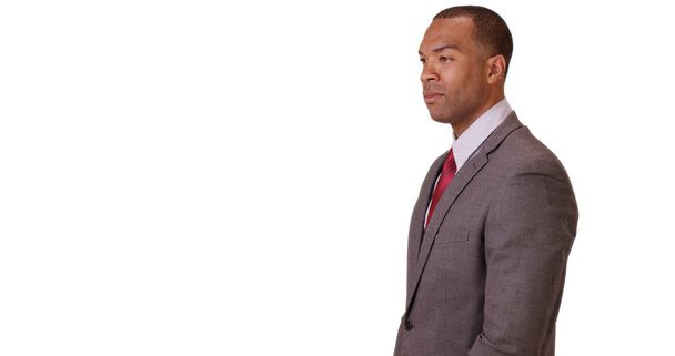 Een zwarte zakenman op zoek vertrouwen op een witte achtergrond - Foto, afbeelding