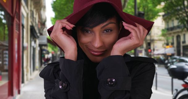 Красивая этническая модница позирует с уверенностью на тротуаре Парижа снаружи
 - Фото, изображение