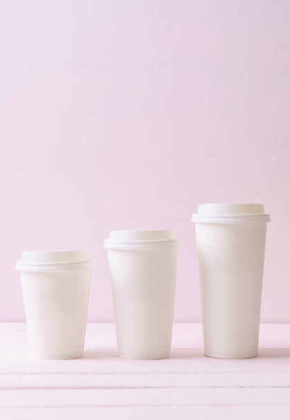 Paper cup of takeaway coffee on wood background - Фото, изображение