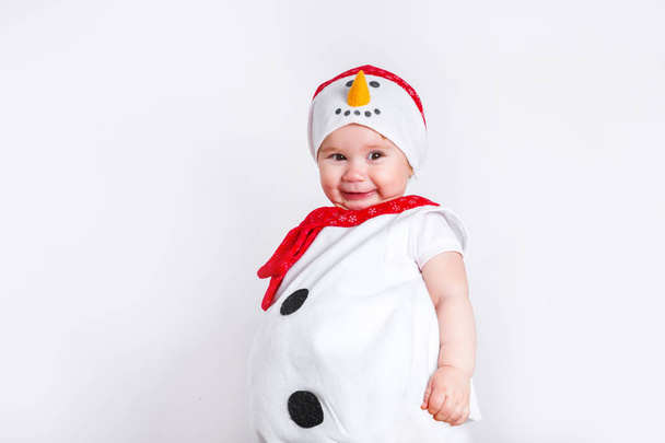 Merry Christmas and Happy New Year. Happy baby girl in snowman costume on white background - Valokuva, kuva