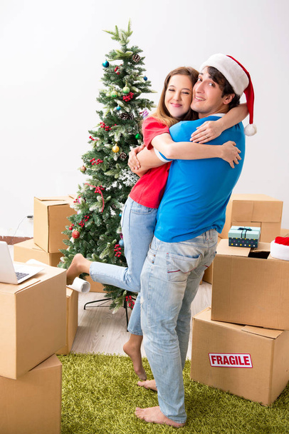 Young family celebrating christmas in new home - Foto, imagen