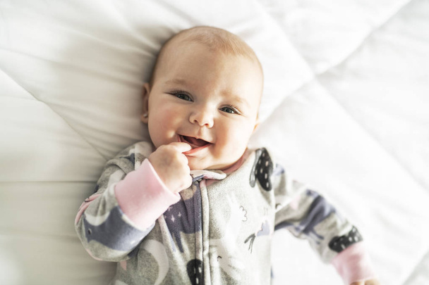 A Cute baby girl on a white bed at home - Фото, зображення