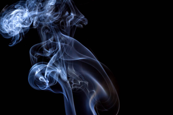 Thick smoke on a black isolated background. Background from the smoke of vape - Photo, Image