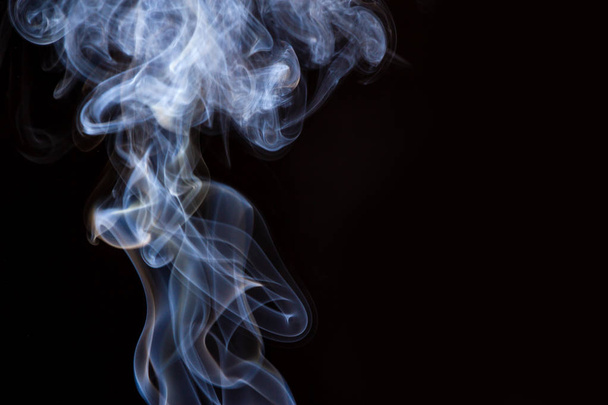 Thick smoke on a black isolated background. Background from the smoke of vape - Photo, Image