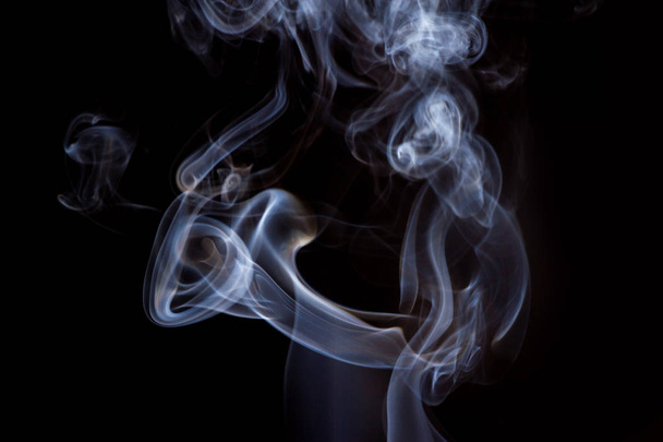 Thick smoke on a black isolated background. Background from the smoke of vape - Foto, Bild