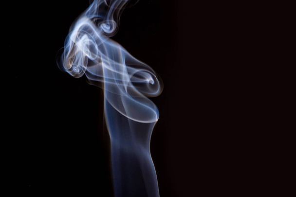 Thick smoke on a black isolated background. Background from the smoke of vape - Foto, Imagen