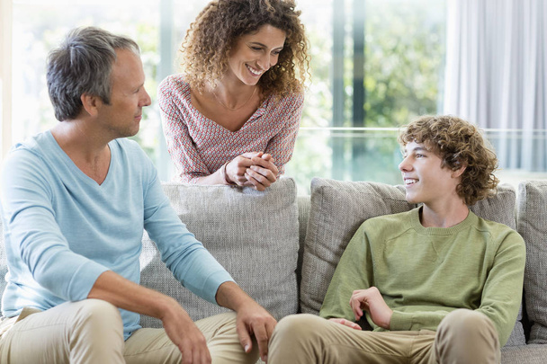 Happy family smiling in living room at home - Photo, Image