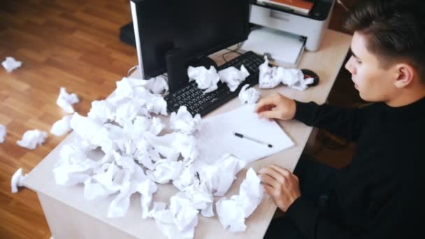 Stressed man throws crumpled paper away from the table. Slow motion. Upper angle - Footage, Video