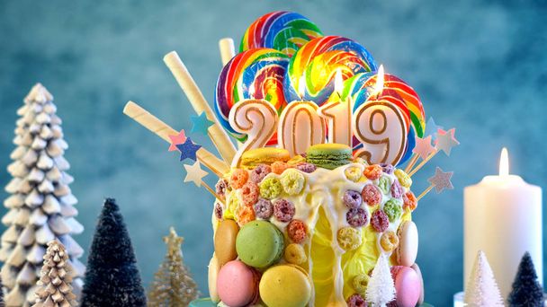 2019 幸せな新しい年キャンディ土地ロリポップ点滴カラフルなパーティー テーブルの設定でケーキ. - 写真・画像