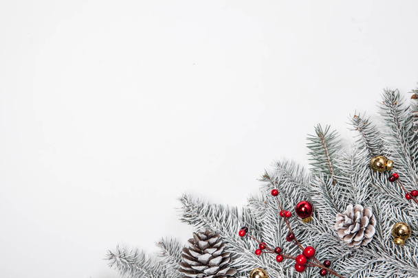 Christmas card. White background with snow fir tree and decoration. Top view with copy space for your text - Foto, imagen