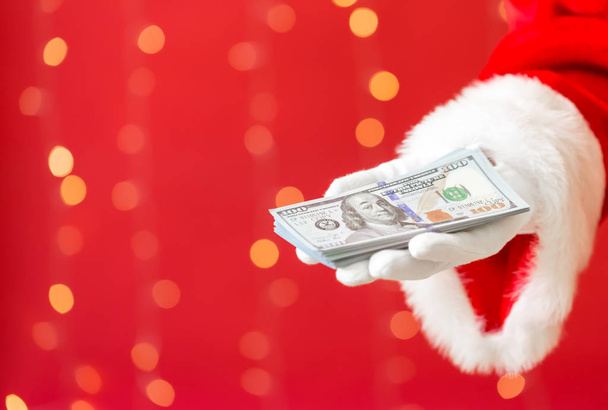 Santa holding US dollar bills - Фото, зображення
