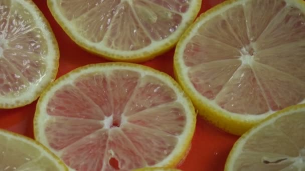 φέτες λεμονιού φρούτων περιστρεφόμενο φόντο - Πλάνα, βίντεο
