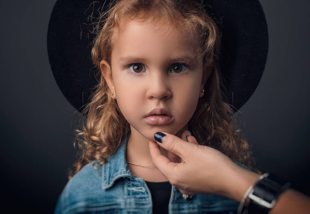 child in the Studio posing in fashionable clothes - Fotó, kép