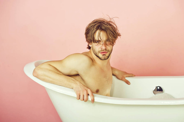 handsome man with sexy bare muscular torso in bathtub - 写真・画像