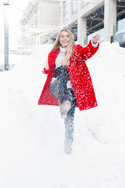 winter, fashion, people concept - fashion Portrait of a beautiful young woman walks around the city smiling red fur coat close-up snowflakes cold winter, breathe fresh air at frost winter day. sunset - Φωτογραφία, εικόνα