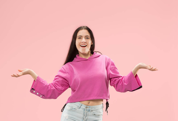 The happy business woman standing and smiling against pink background. - Foto, imagen