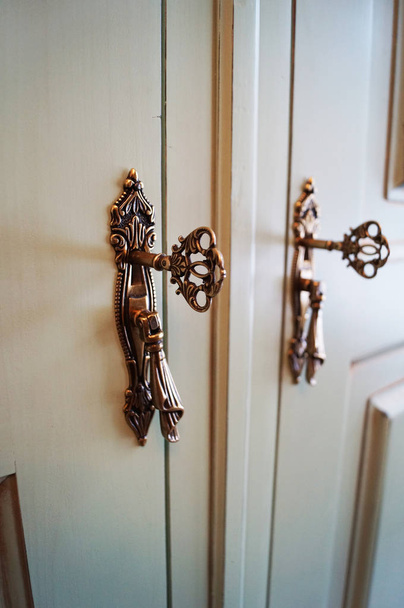 Beautiful vintage handles, keys, locks in the closet cabinet - 写真・画像