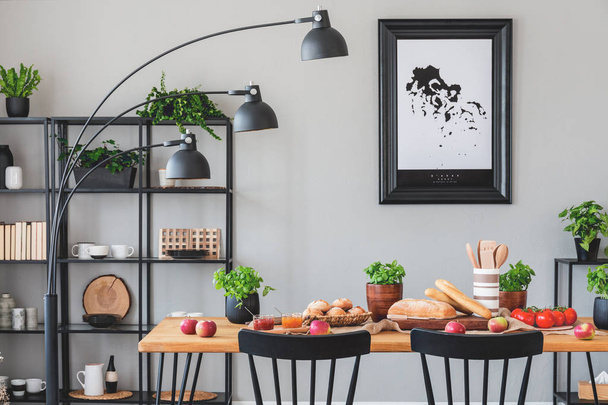 Black lamp above wooden table with eco food in grey dining room interior with plants and poster. Real photo - Φωτογραφία, εικόνα