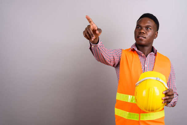 Young African man construction worker against white background - Photo, Image