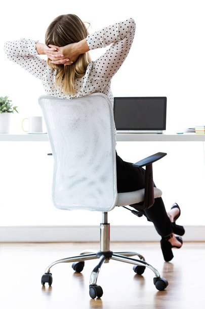 Shot of businesswoman stretching relaxing on moment in her office. Satisfied with work done concept. - Fotó, kép