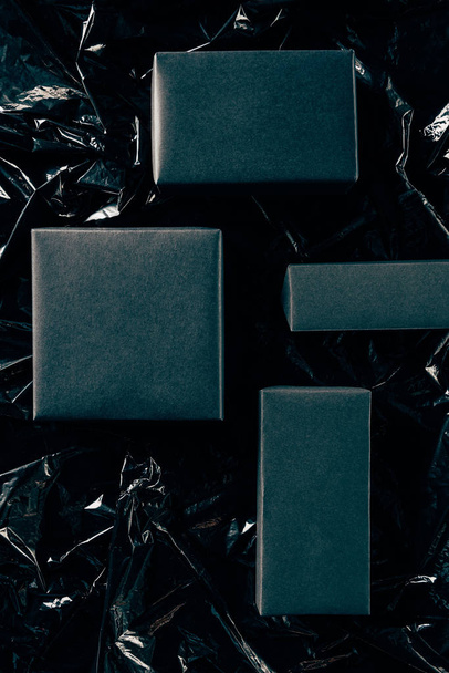 flat lay with blank boxes on black wrapping paper backdrop, black friday concept - Фото, зображення
